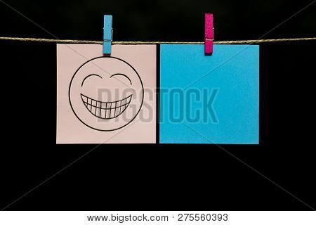 Copy Space. Two Stickers. On Gray Page Smiley. Gaiety. Stickers Are Attached To The Rope With Clothe