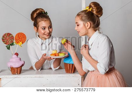Beautiful Teenage Girls In Pink Tutu Skirts With Lollipops And Macaroons And Fansy Cakes In Studio O