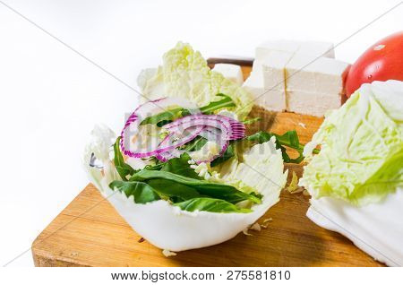 Peking cabbage and other vegetables. Red onion. Front view.
