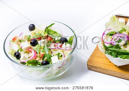 Cooked salad and vegetables on the board. Cutting board and vegetables. Front.