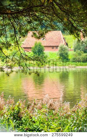 View Through Summer Flora On Country Village Cabin On The Coast Of Nemun River In Nemun National Par