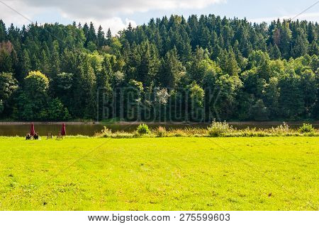 People Resting, Sitting On Scenic Coast Of The River Nemun In The National Park Nemun Surrounded By 
