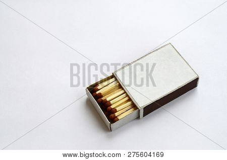 Open Cardboard Matchbox Filled With Matches On A White Background