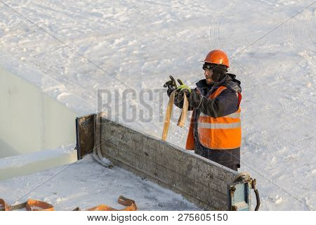 Slinger In An Orange Helmet At The Installation Site