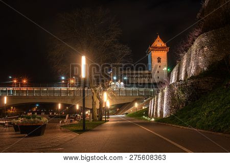 Night View Of Narva Castle With The Tower Of High Herman, Narva, Estonia. The Castle Is Illuminated.