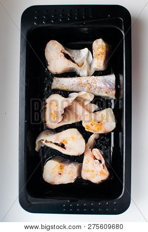 Slices Of Pollock In Baking Dish. Plate Of Cod Or Pollack Fish Fillet Stewed. Cooking Process.