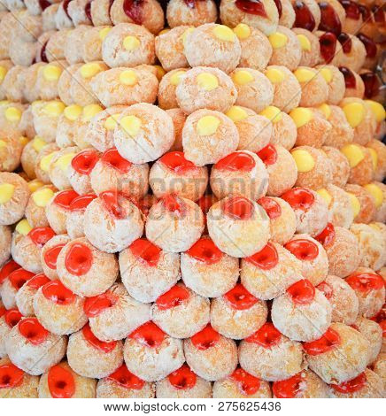 donuts with Strawberry and Vanilla jam in the bakery / pile of fresh donuts background