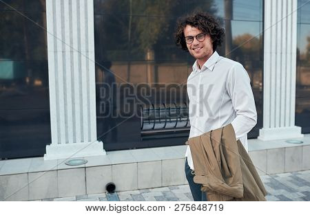 Handsome Young Positive Businessman With Glasses Posing Outdoors. College Male Student On The Street