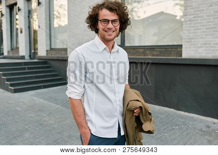 Handsome Young Happy Businessman With Glasses Smiling And Posing Outdoors. Male Student In Autumn St