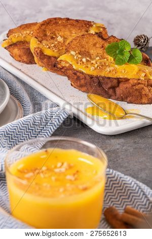 Traditional Christmas Rabanadas With Egg Yolk Cream And Cinnamon. Spanish Torrijas Close Up On The C