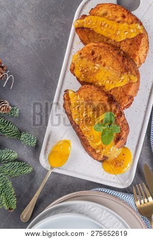 Traditional Christmas Rabanadas with egg yolk cream and cinnamon. Spanish Torrijas close up on the countertop.