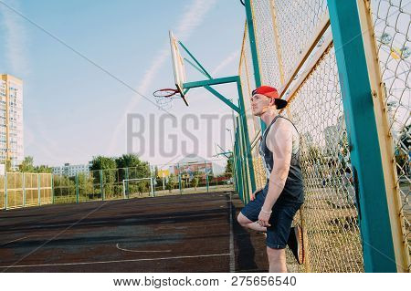 Guy In A Red Baseball Cap On The Basketball Court