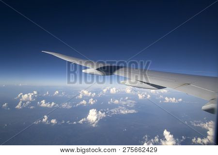 Wing Of A Commercial Passenger Plane. Photo Taken From The Airplane Window During A Flight From Amst