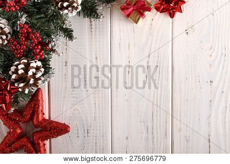 Spruce Branches, Cones And Red Berries On A White Wooden Background. Background For Christmas And Ne