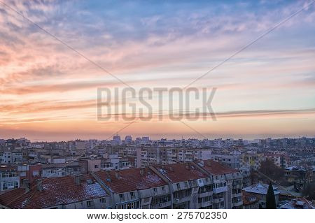 The Picturesque Sunset Sky With Blue-orange Clouds. Winter Cityscape And Urban Skyline At Sunset Tim
