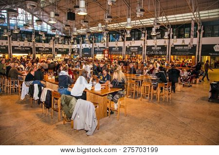 LISBON, PORTUGAL - OCT 30, 2018, 2018: People eat at TimeOut Market in Lisbon, Portugal. TimeOut Market is a unique attempt to bring all best restaurants in Lisbon at one place.