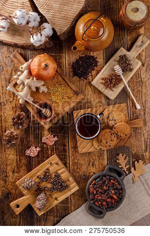 Autumn Winter Still Life. A Teapot And A Cup Of Tea On A Wooden Table With Different Goodies. The Ap