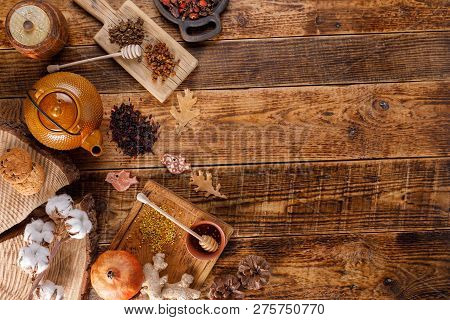 Autumn Winter Still Life. Teapot With Tea On A Wooden Table With Honey Ginger And Rosehip. The Apart