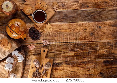 Autumn Winter Still Life. Teapot With Tea On A Wooden Table With Honey And Oatmeal Cookies. The Apar