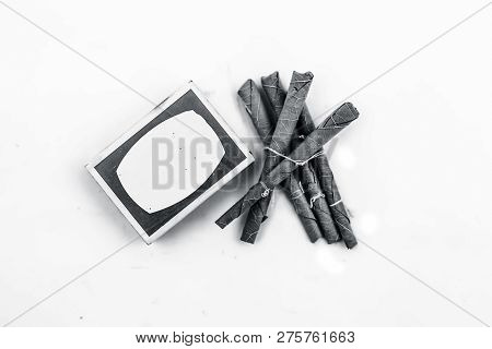 Close Up Of Mini Cigar Or Mini Cigarette Or Bidi Or Beedi Isolated On White With A Matchbox.