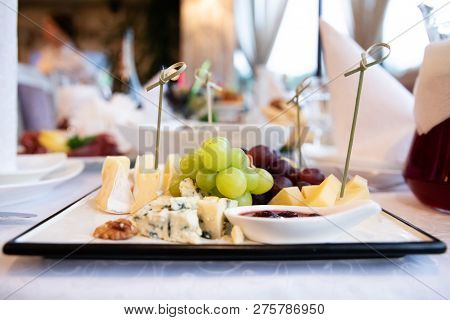 Plate With Cheese On The Table In Restaurant