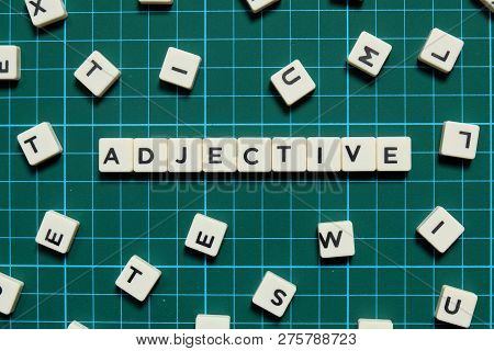 Adjective Word Made Of Square Letter Word On Green Square Mat Background.