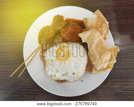 Selective Focus Of Fried Rice With Satay Egg And Papadum