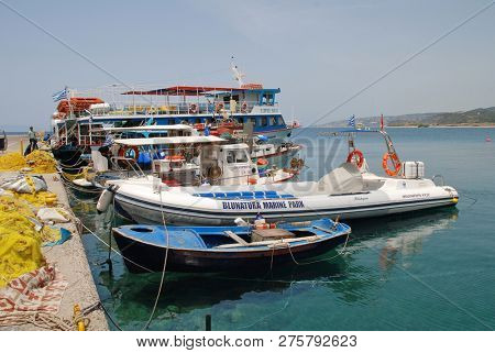 RHODES, GREECE - JUNE 7, 2017: Boats moored at Kamiros Skala harbour on the Greek island of Rhodes. The port is a departure point for ferries to the islands of Halki and Tilos.