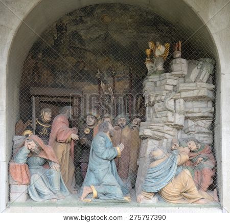 LUCERNE, SWITZERLAND - JUNE 24, 2018: Jesus on the Mount of Olives, surrounded by approaching soldiers and the Apostles, portal of the church of St. Leodegar in Lucerne, Switzerland