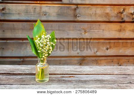Bouquet Of Flowers Beautiful Smell Lily Of The Valley Or May-lily In Glass Vase On Rustic Old Vintag