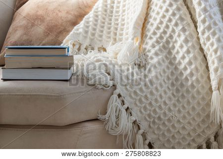Stylish Brightly Interior Of Living Room. Inviting Comfortable Sofa With Handmade Woolen Blanket And