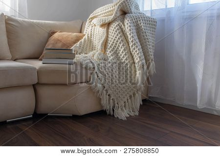 Stylish Brightly Interior Of Living Room. Inviting Comfortable Sofa With Handmade Woolen Blanket And