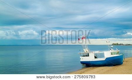 Fishing Boat On Baltic Sea Coast. Stormy Weather. Mechelinki, Poland, Pucka Bay.
