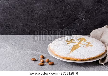 Tarta De Santiago. Traditional Almond Cake From Santiago In Spain On Gray Background. Copyspace