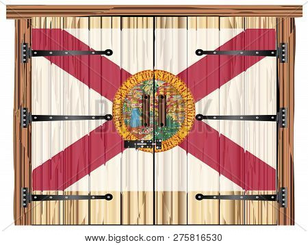 A Large Closed Wooden Barn Double Door With Bolt And Hinges And The Florida Flag Painted On