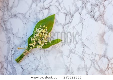Bouquet Of Flowers Beautiful Smell Lily Of The Valley Or May-lily On Marble Background. Garden In Sp