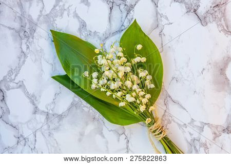 Bouquet Of Flowers Beautiful Smell Lily Of The Valley Or May-lily On Marble Background. Garden In Sp