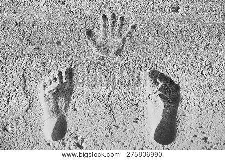 Handprint And Footprints On Sand. Human Imprints, Prints, Tracks On Sandy Surface. Palm, Fingers, Fe