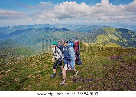 Couple - Active Hikers Hiking Enjoying View Looking At Mountain Forest Landscape In Yosemite Nationa