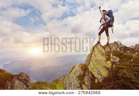 Successful Young Woman Backpacker Open Arms On Mountain Peak