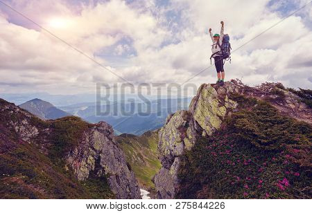 Cheering Young Woman Backpacker At Sunrise Seaside Mountain Peak