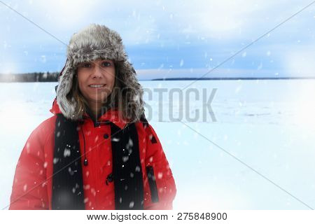 Winter Portrait Of A Woman Wearing An Furry Aviation Hat And Red Jacket