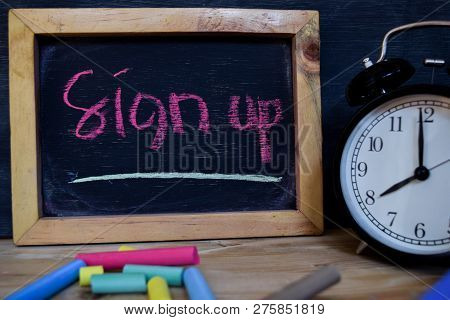 Sign Up. Back To School Concept. Alarm Clock On Wooden With Blackboard On Background