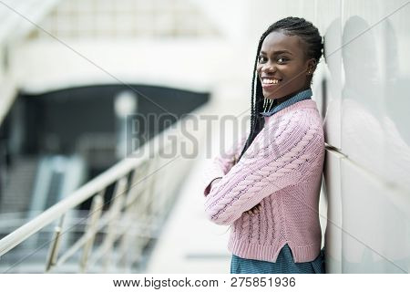 Young Afro American Woman With Crossed Hands Standing In Office Hall