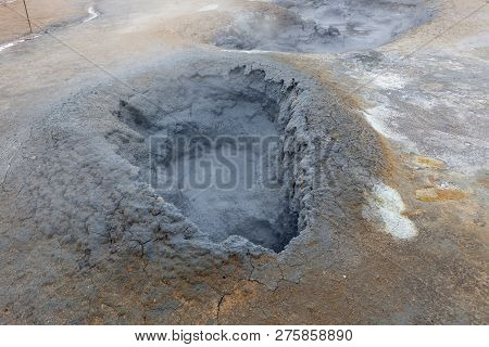 Grey Hot Mud Bubbling In A Hole At The Geothermal Active Area Of Hverir In Iceland. Fumarole Field O