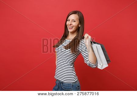 Portrait Of Smiling Young Woman In Striped Clothes Holding Packa