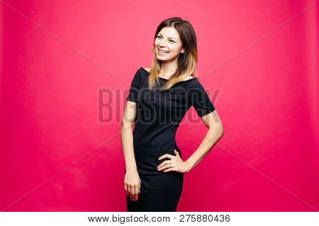 Woman In Black Dress Lauthing Emotionaly Posing With Hands On Waist.