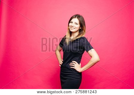 Woman In Black Dress Lauthing Emotionaly Posing With Hands On Waist.
