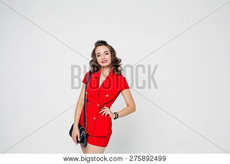 Beautiful Woman In Red Suit And Bag Showing Thumb Up.