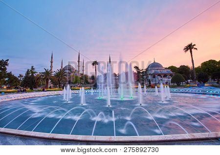 Colorful Spring Sunset In Sultan Ahmet Park In Istanbul, Turkey, Europe. Colorful Fountain On The Ba